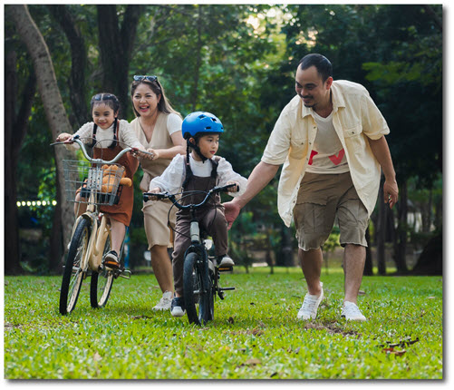 Family learning how to ride bicycles