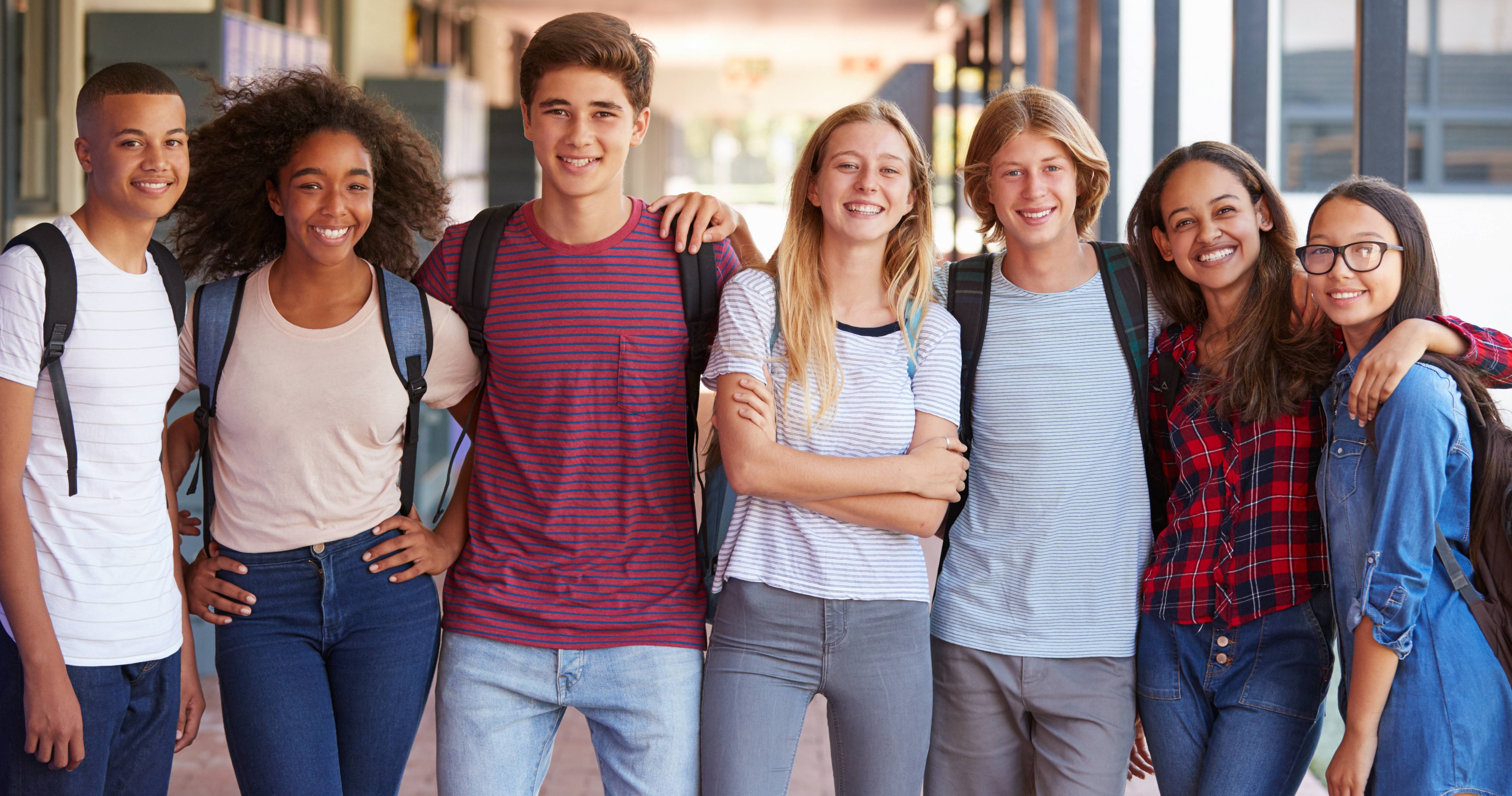 seven high school students standing in a row